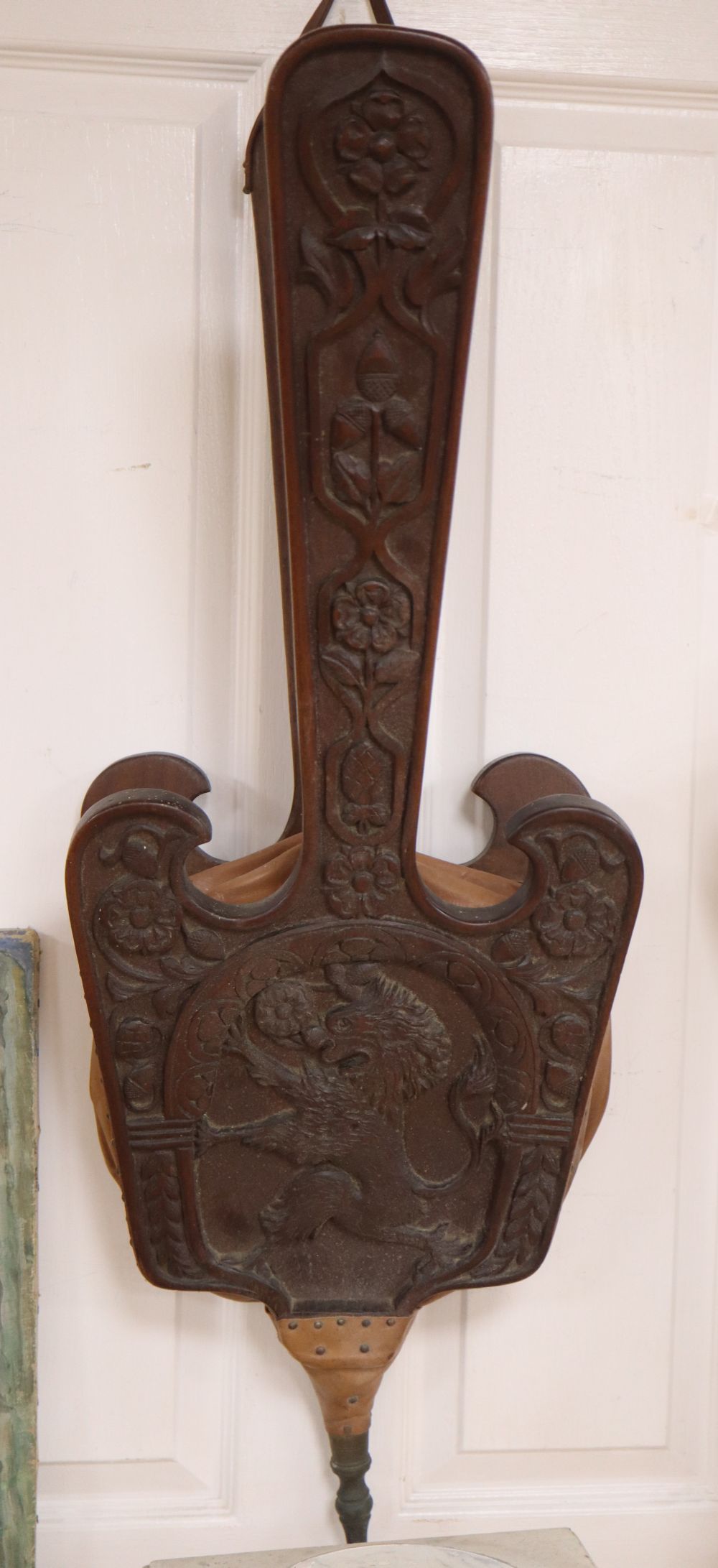 A large pair of carved oak fire bellows